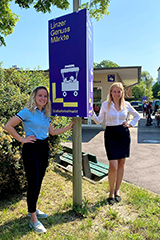Zwei Frauen mit Hinweisschild